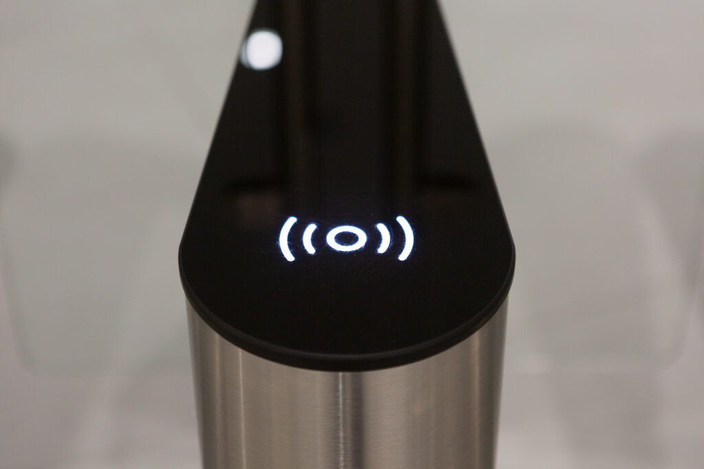 A building access point with silver base and black top, and illuminated symbol indicating where GovPass should be placed.