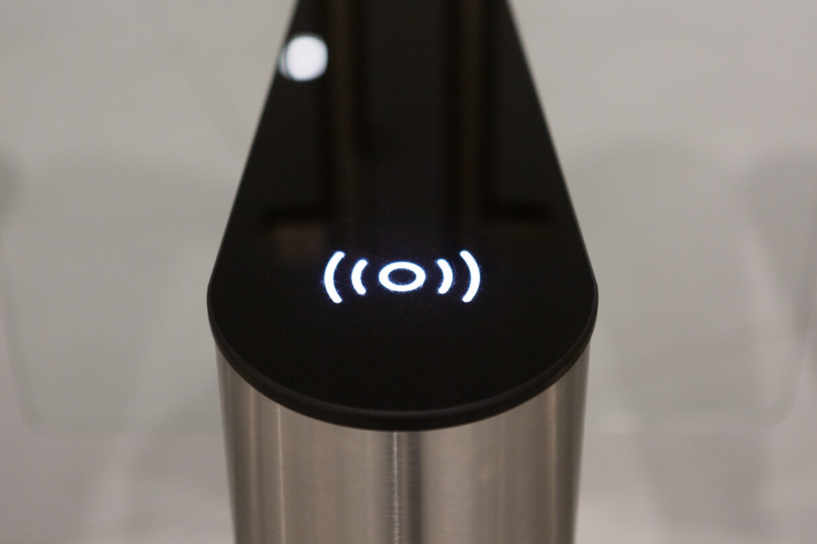 A building access point with silver base and black top, and illuminated symbol indicating where GovPass should be placed.