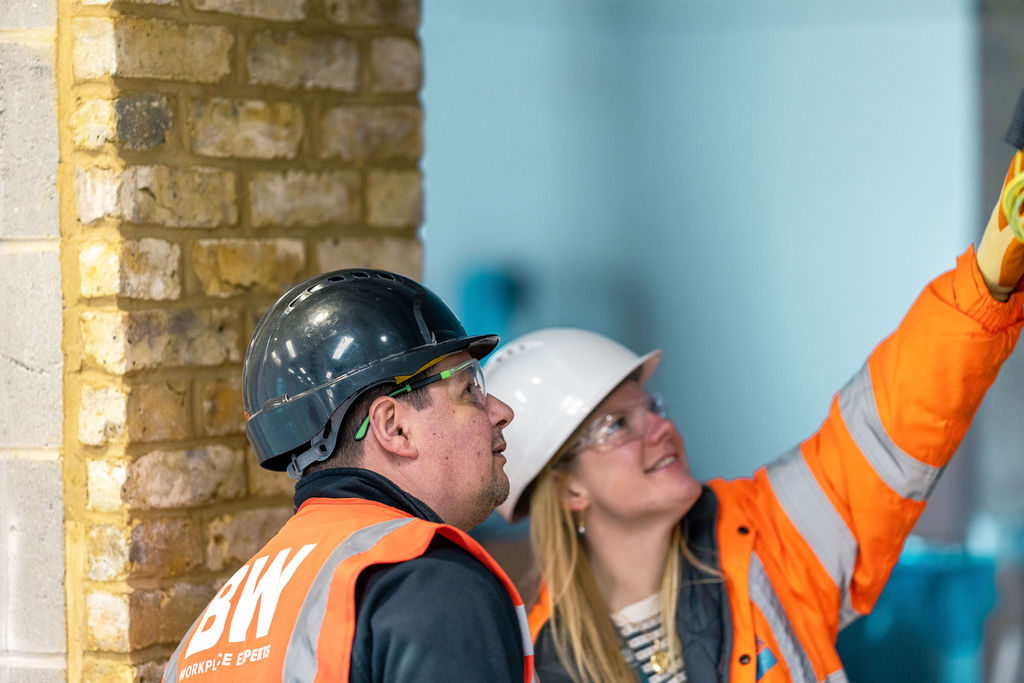 Refurbishment in our iconic, London, Whitehall building- two builders looking and pointing at something.
