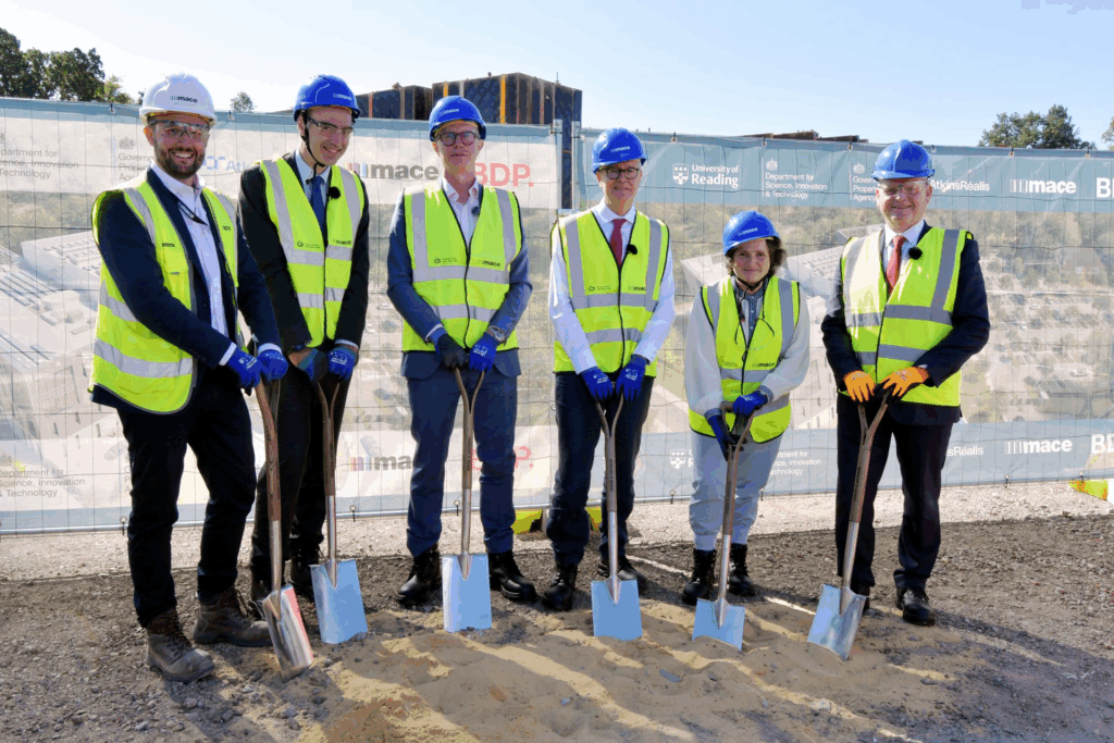 6 leaders stand at the site holding spades to initiate the ground breaking ceremony