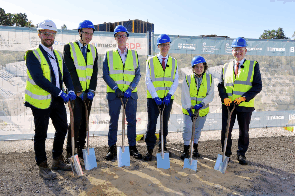 6 leaders stand at the site holding spades to initiate the ground breaking ceremony