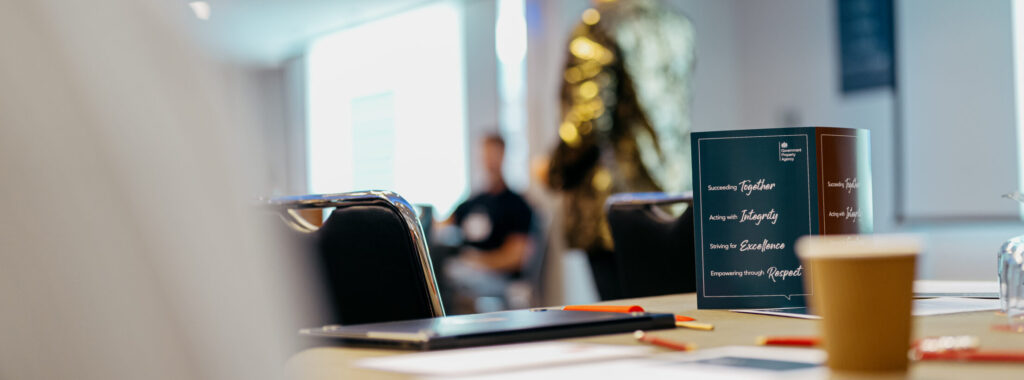 A table centrepiece showing the corporate values written in text: Succeeding together, Acting with integrity, Striving for excellence and Empowering through respect